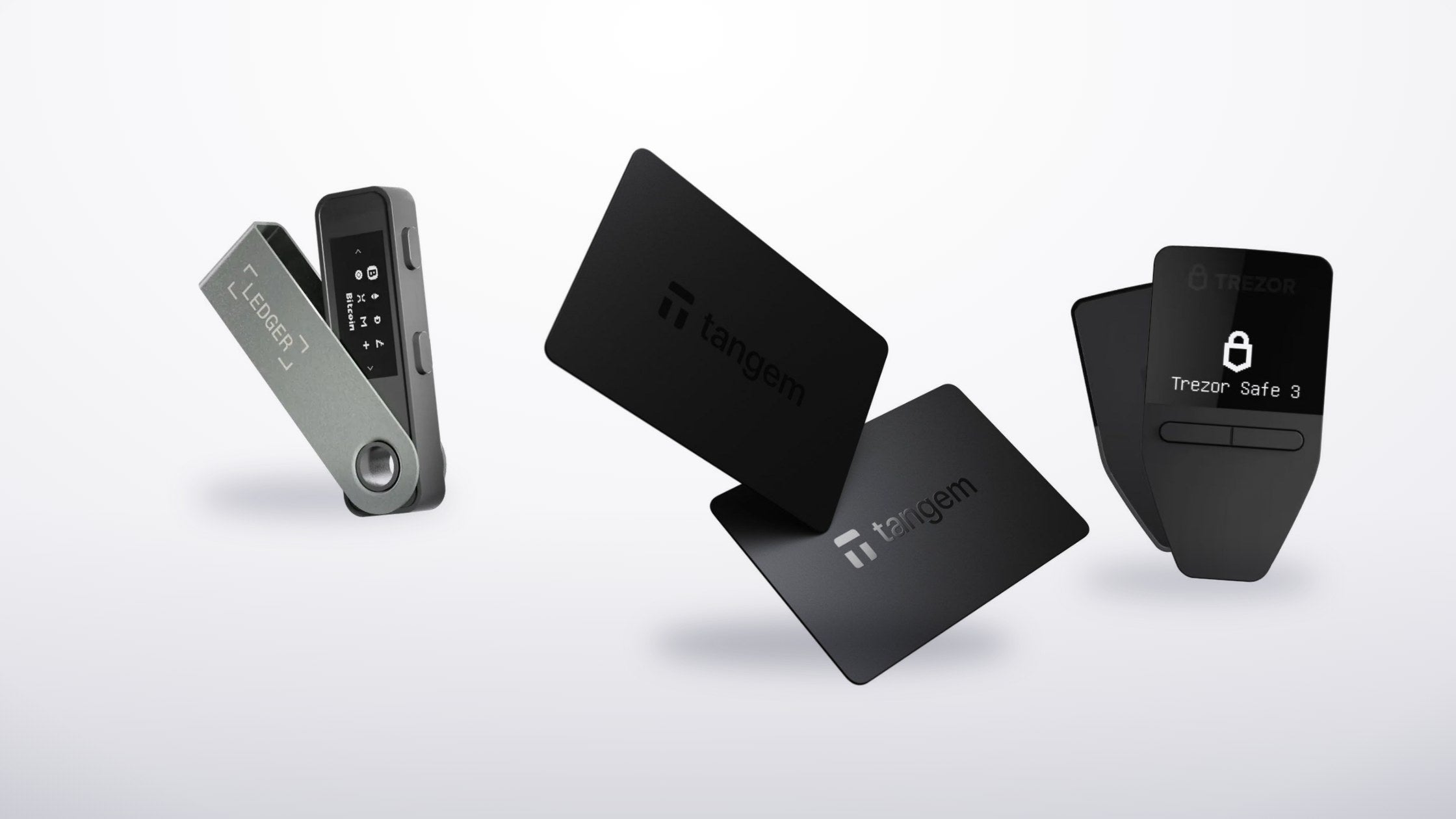 Ledger Nano S Plus, Tangem Wallet cards and Trezor Safe 3 hardware wallets on a light studio background