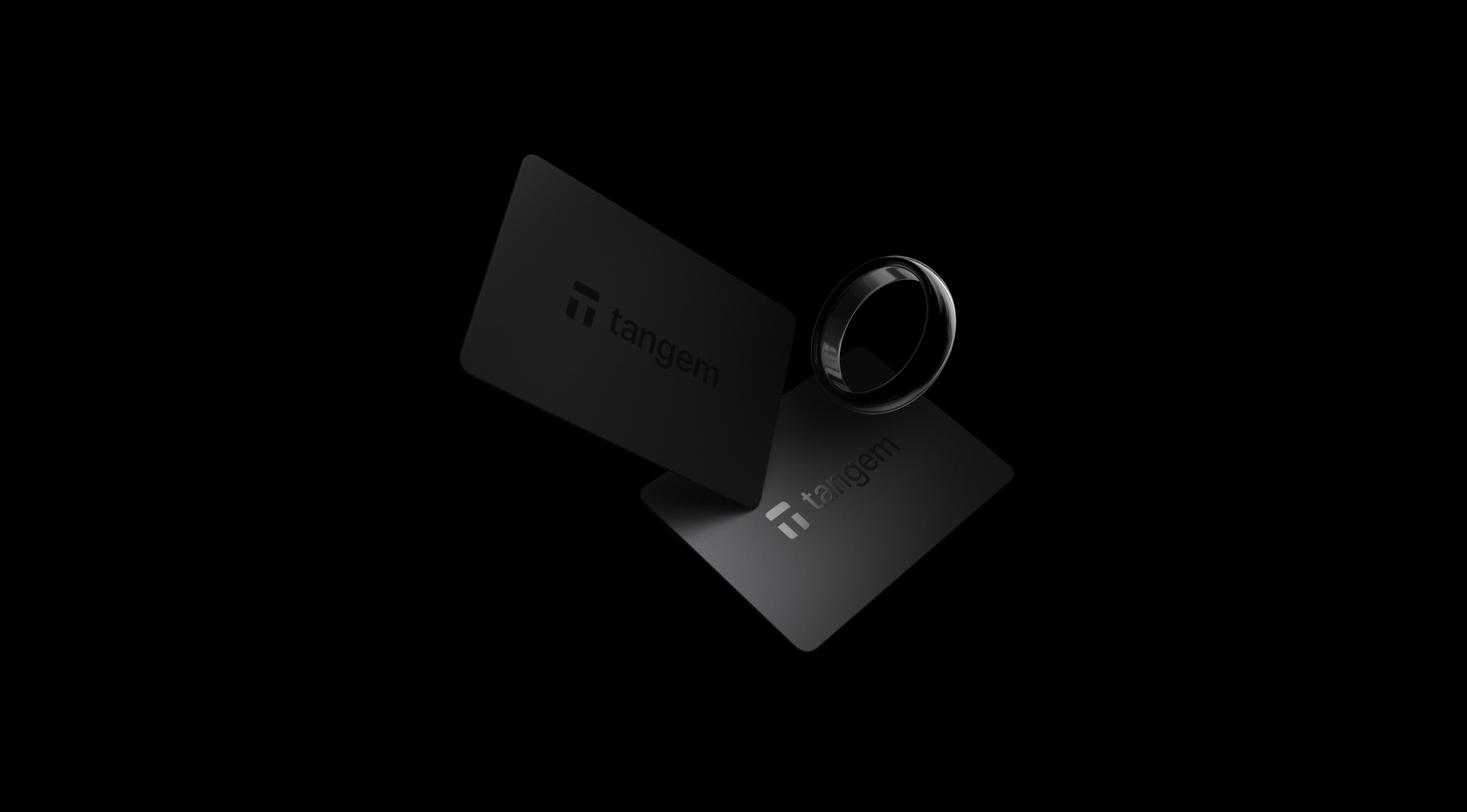Tangem Ring and two Tangem Wallet cards on a black background